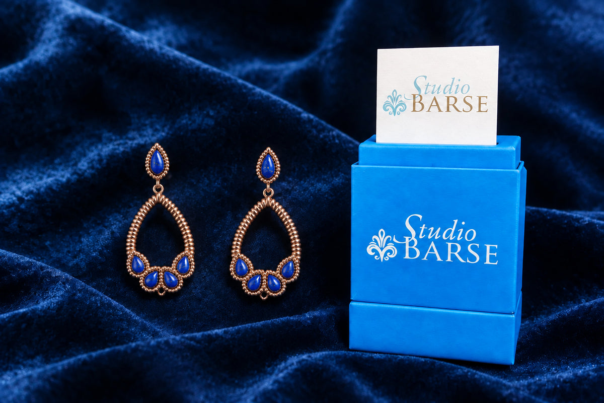 Barse earrings displayed beside Studio Barse packaging