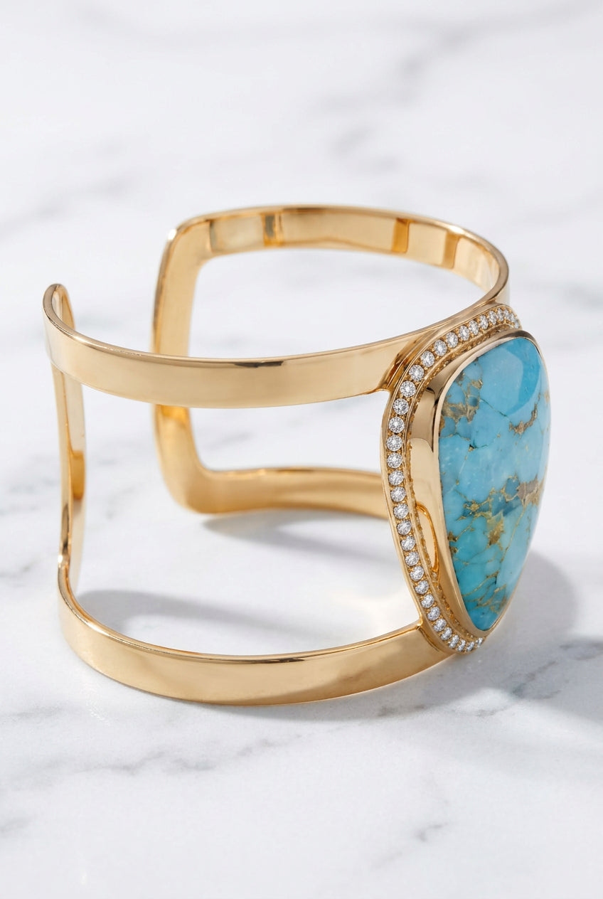 Side view showing spaced gold-tone bands and raised blue cabochon setting