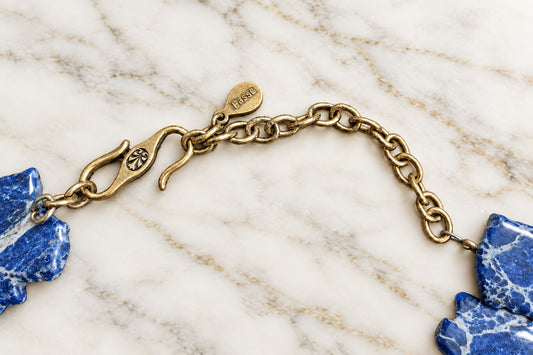 Close-up of Barse signature tag, hook closure and antiqued bronze extender chain
