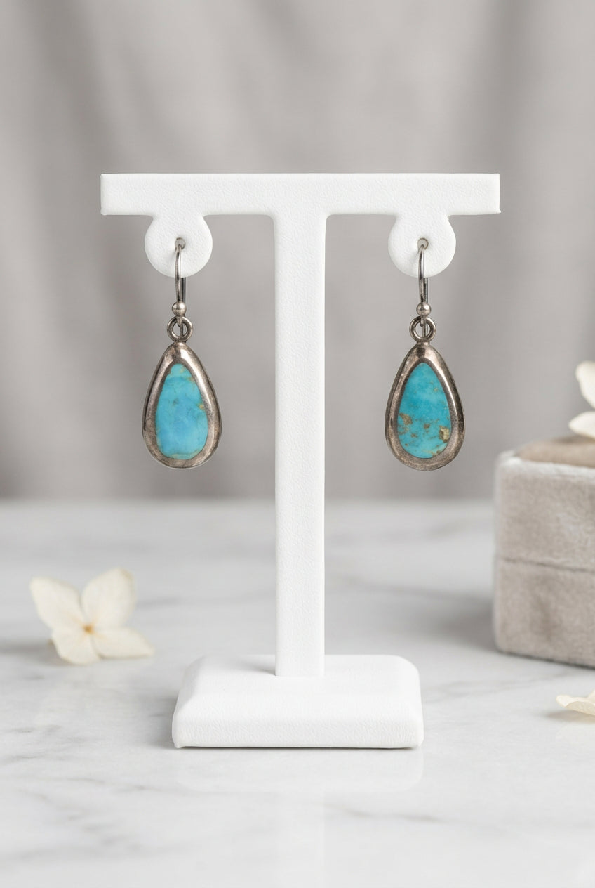 Front of blue turquoise teardrop earrings signed Barse with hook ear wires